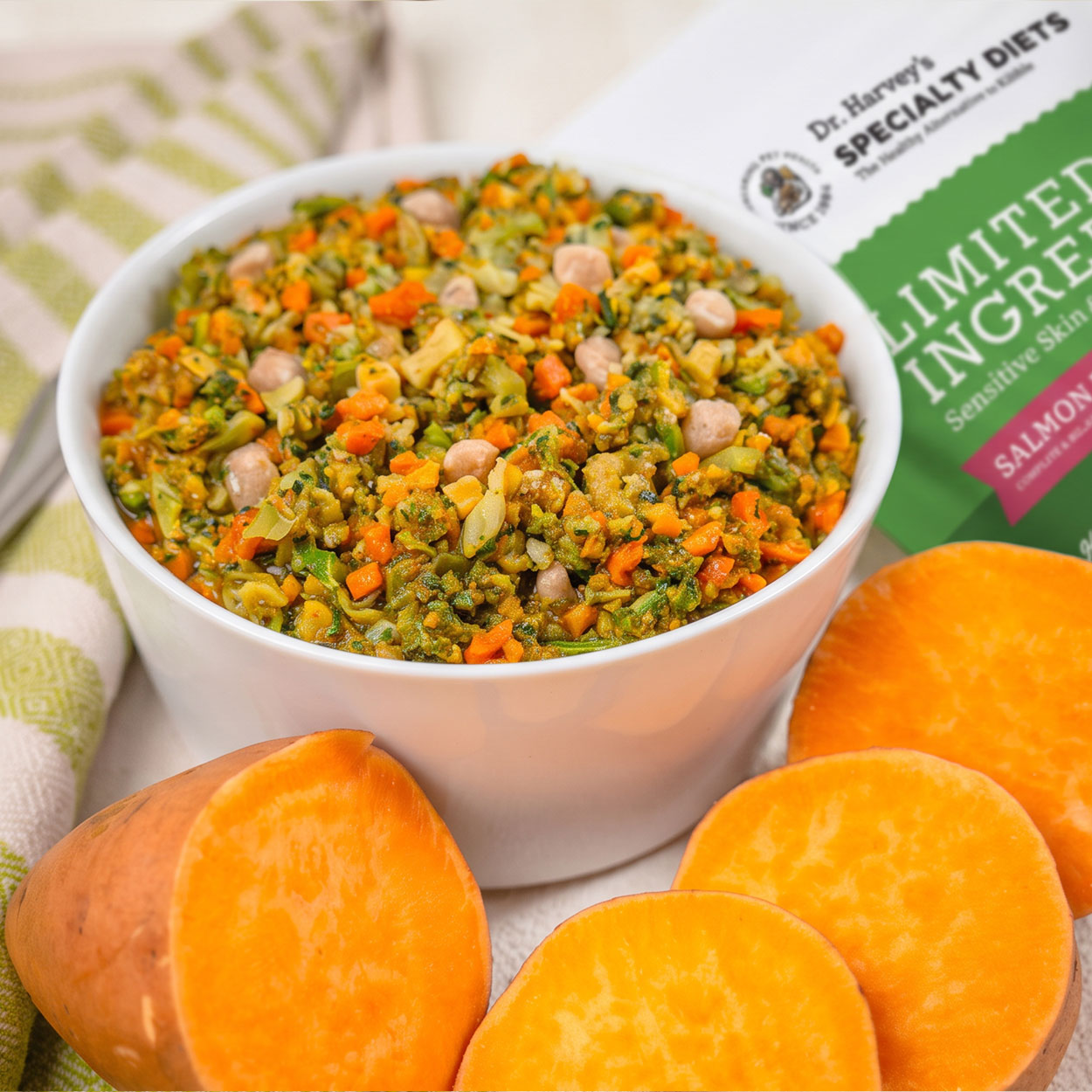 Bowl of chopped vegetables with sweet potato slices and Nature's Recipe Limited Ingredient Salmon Recipe dog food bag